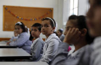 Students sit in their class on the first day of the new school year at the United-Nation run Elementary School at the Shati refugee camp in Gaza City, Saturday, Aug. 8, 2020. Schools run by both Palestinian government and the U.N. Refugee and Works Agency (UNRWA) have opened almost normally in the Gaza Strip after five months in which no cases of community transmission of the coronavirus had been recorded. (AP Photo/Adel Hana)