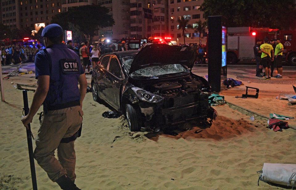 <p>The scene of a car crash pictured at Copacabana beach in Rio de Janeiro on Jan. 18, 2018. (Photo: Carl de Souza/AFP/Getty Images) </p>