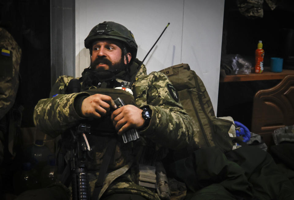 A Ukrainian officer sits in a shelter in Soledar, the site of heavy battles with Russian forces in the Donetsk region, Ukraine, Sunday, Jan. 8, 2023. (AP Photo/Roman Chop)