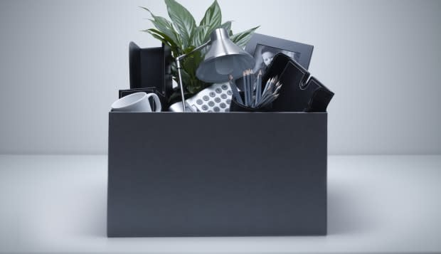 Box packed with desk objects