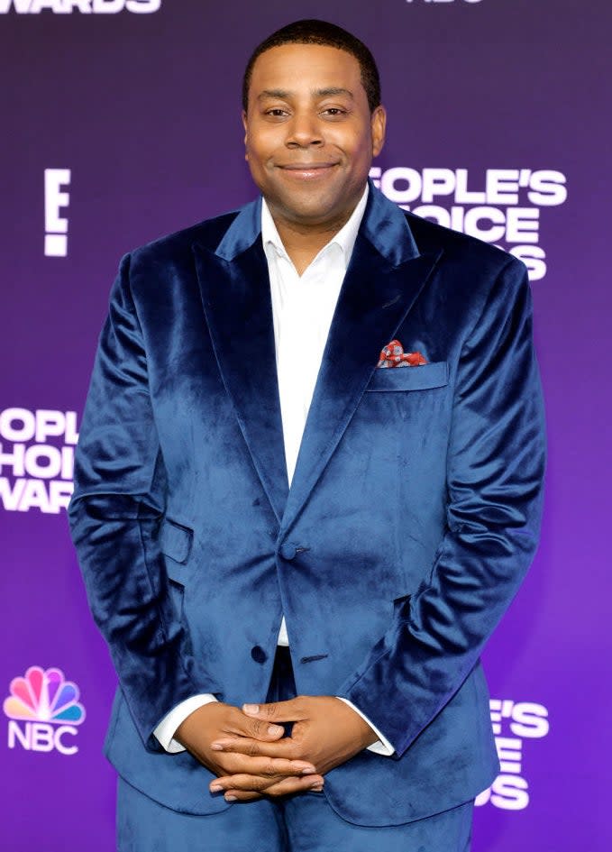 Smiling Kenan in a velvety-looking suit, no tie