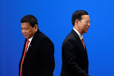 Chinese Vice-Premier Zhang Gaoli (R) walks by Philippines President Rodrigo Duterte after he made a speech during the Philippines - China Trade and Investment Forum at the Great Hall of the People in Beijing, China, October 20, 2016. REUTERS/ Wu Hong/ Pool