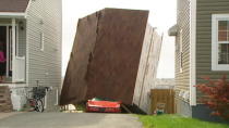 Post-tropical storm Leslie headed out to sea Tuesday afternoon, leaving behind a path of destruction in Newfoundland that included toppled trees, torn power lines and roofs ripped apart from buildings