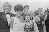 <p>Joan Collins arrives at the 36th Annual Emmy Awards with her husband and daughter in tow. She was nominated for her role in <em>Dynasty</em>. </p>