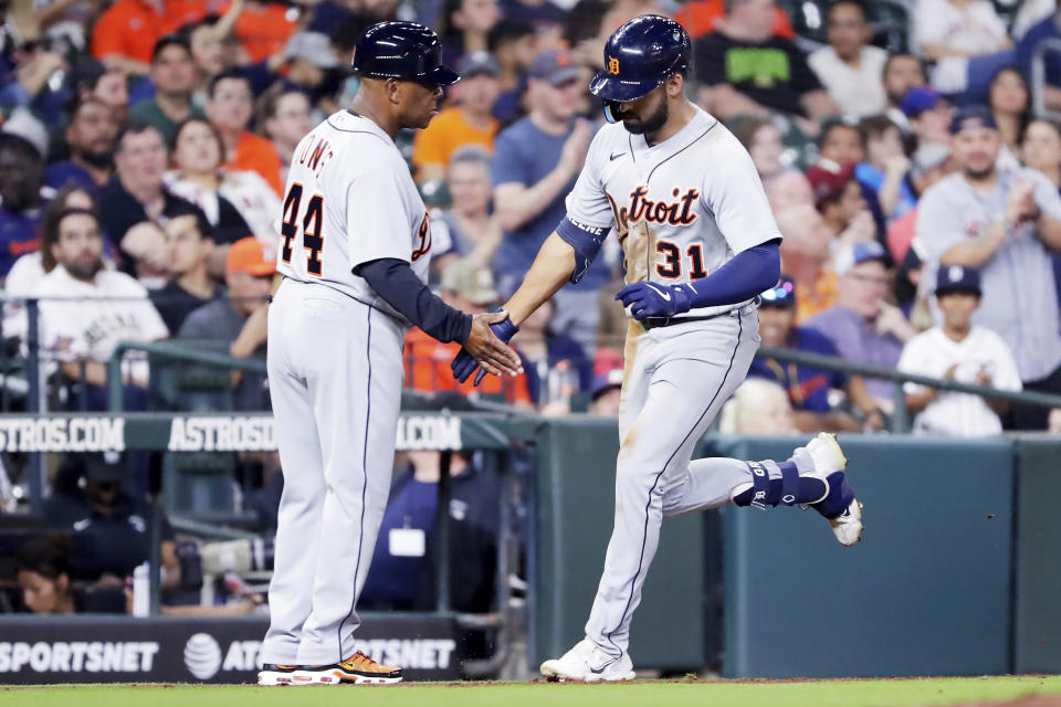 Detroit Tigers third base coach Gary Jones (44) and Riley Greene (31) celebrate after Greene's home run as he rounds third base during the seventh inning of a baseball game against the Houston Astros, Monday, April 3, 2023, in Houston. (AP Photo/Michael Wyke)