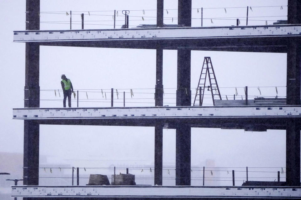 A man works on a building in a snow storm in Lehi, Utah, on Dec. 13, 2022. (George Frey / AFP - Getty Images)