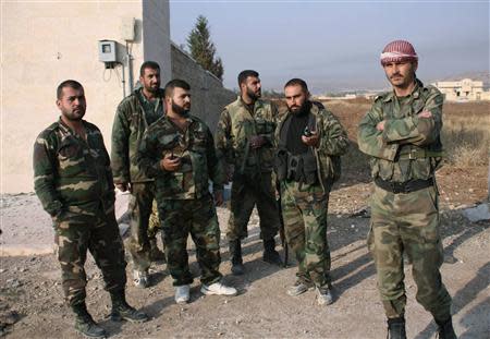 Forces loyal to Syria's President Bashar al-Assad stand in the town of Safira November 1, 2013. REUTERS/George Ourfalian