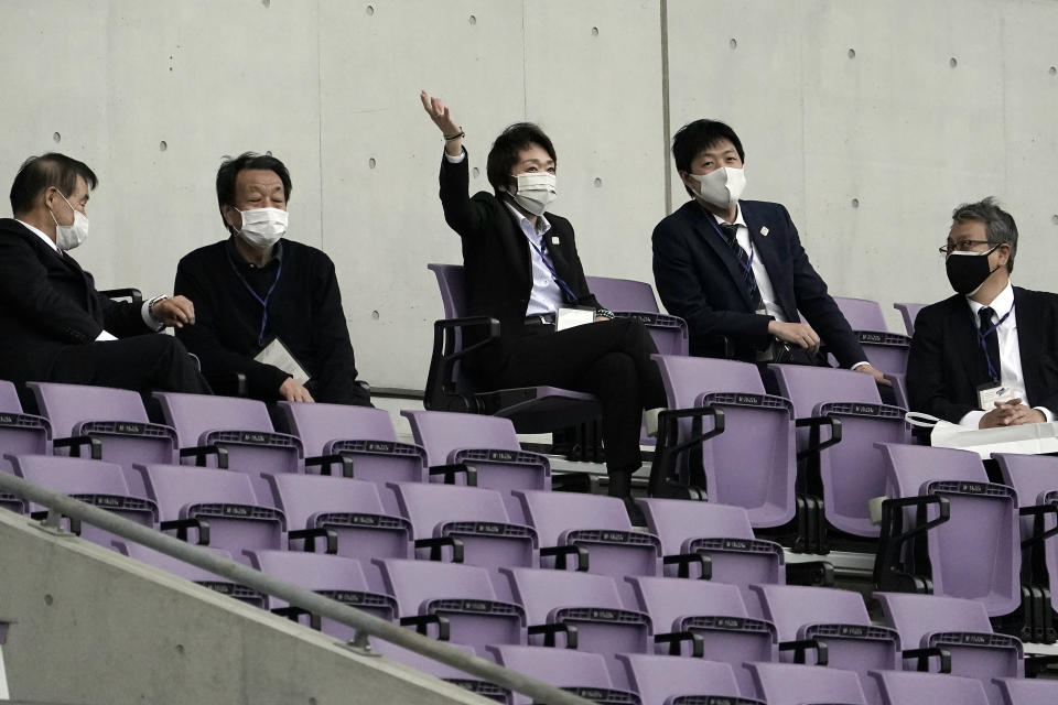 Tokyo 2020 Organizing Committee President Seiko Hashimoto, center gestures as she observes Japan women's national team candidates staging a match in the operational test event of Rugby in preparation for the Tokyo 2020 Olympic Games at Tokyo Stadium Thursday, April 22, 2021, in Tokyo. (AP Photo/Eugene Hoshiko)