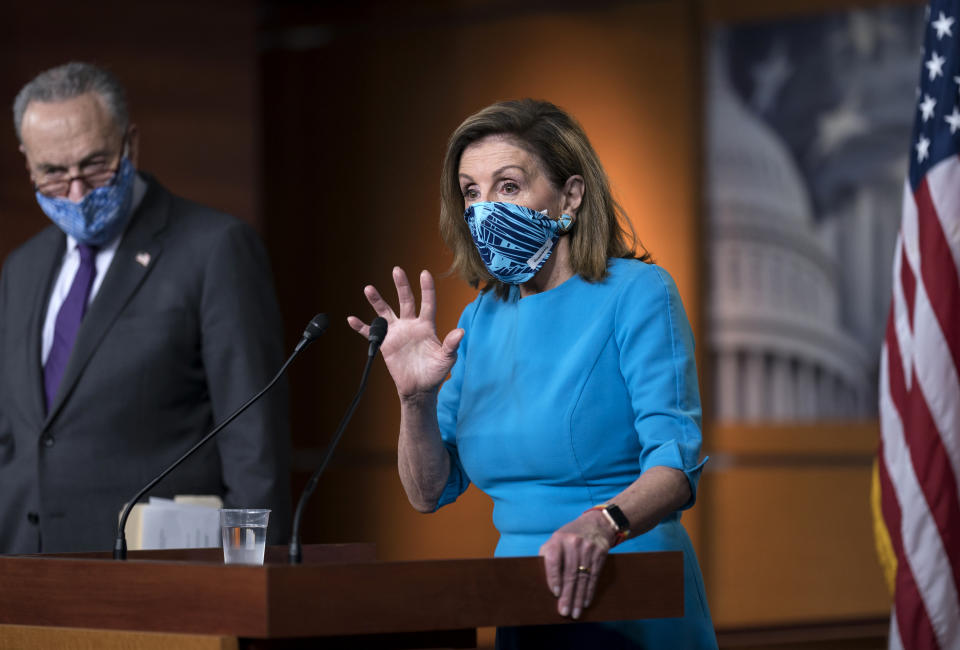 Speaker of the House Nancy Pelosi, D-Calif., and Senate Minority Leader Chuck Schumer, D-N.Y., left, meet with reporters on Capitol Hill in Washington, Thursday, Nov. 12, 2020. (AP Photo/J. Scott Applewhite)