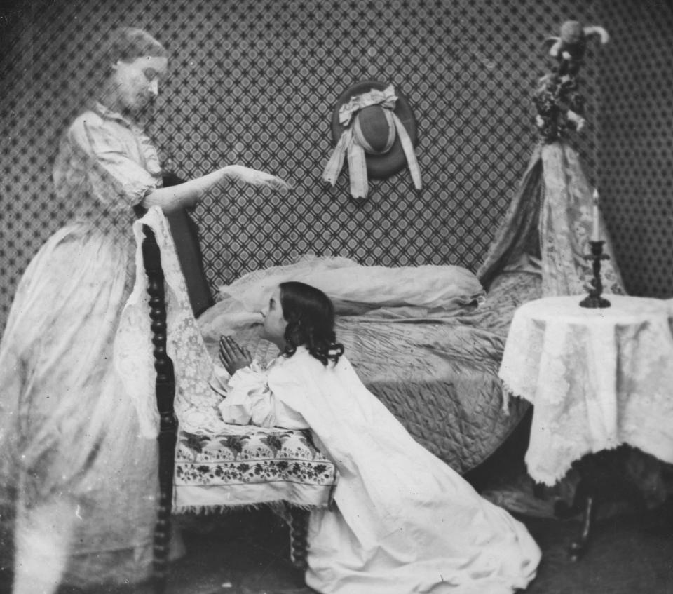 circa 1865: The ghost of a woman appears to a girl at prayer by her bedside. London Stereoscopic Company Comic Series - 183 (Photo by London Stereoscopic Company/Getty Images)