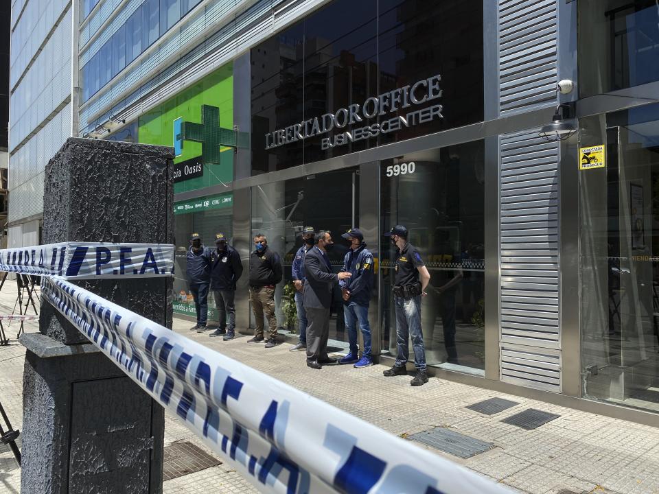 Police guard the entrance to Dr. Leopoldo Luque's practice in Buenos Aires, Argentina, Sunday, Nov. 29, 2020. Luque was Diego Maradona's personal doctor, and his house and offices were raided Sunday in the midst of investigations to establish the circumstances of Maradona's death. (AP Photo/Leo La Valle)