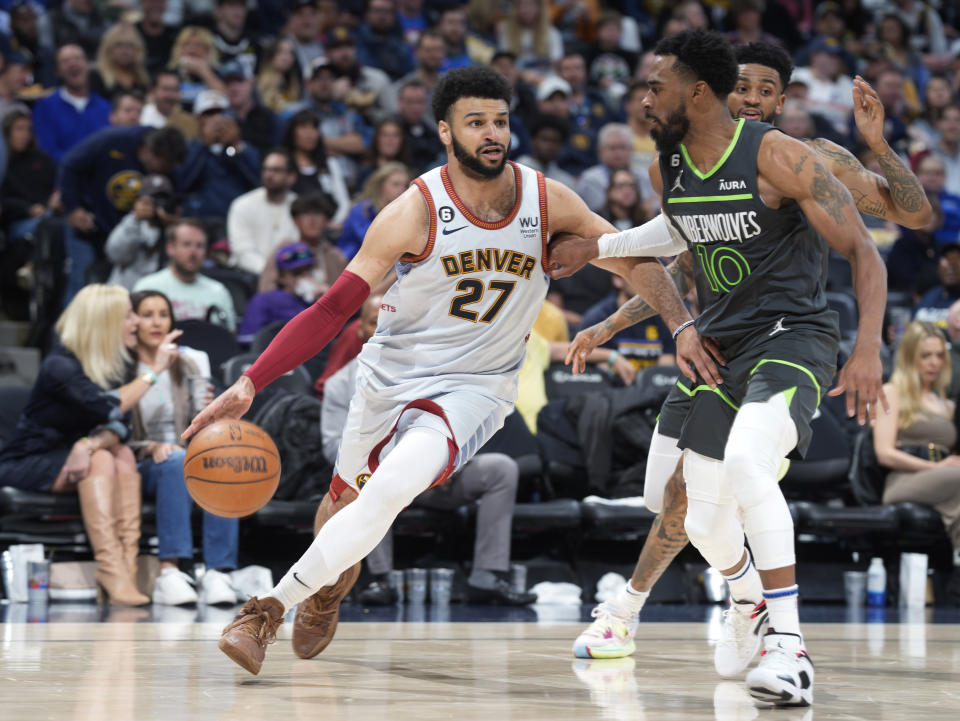 Denver Nuggets guard Jamal Murray, left, drives against Minnesota Timberwolves guard Mike Conley during the second half of Game 5 of an NBA basketball first-round playoff series Tuesday, April 25, 2023, in Denver. (AP Photo/David Zalubowski)