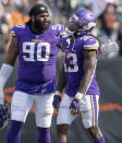 Minnesota Vikings defensive tackle Sheldon Richardson (90) pats Dalvin Cook (33) on the back after Cook fumbled the ball in overtime of an NFL football game against the Cincinnati Bengals, Sunday, Sept. 12, 2021, in Cincinnati. (Carlos Gonzalez/Star Tribune via AP)