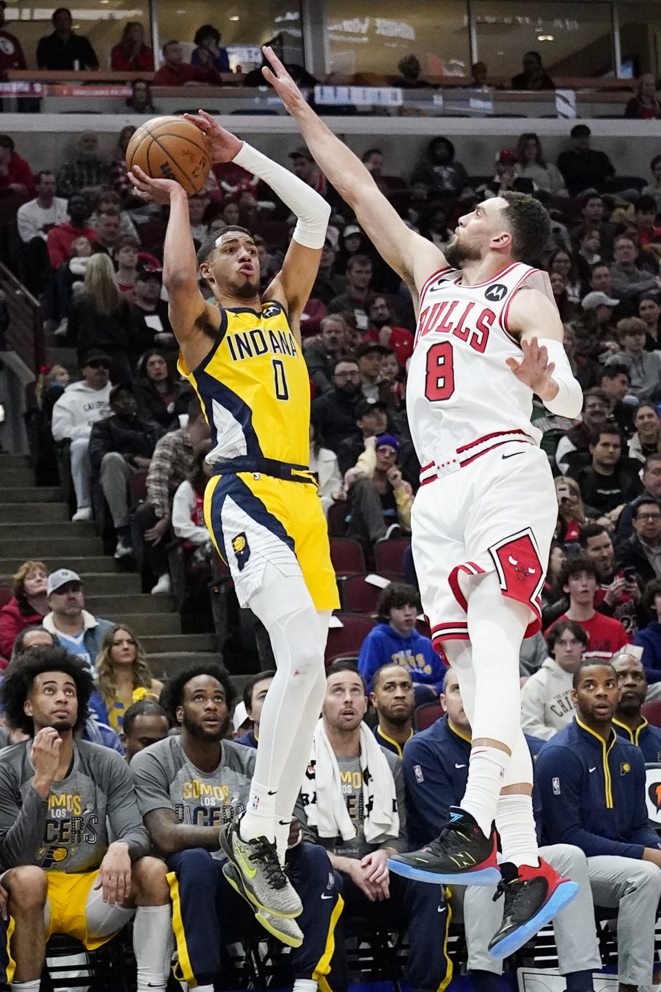 Indiana Pacers guard Tyrese Haliburton, left, shoots against Chicago Bulls guard Zach LaVine during the first half of an NBA basketball game in Chicago, Sunday, March 5, 2023. (AP Photo/Nam Y. Huh)
