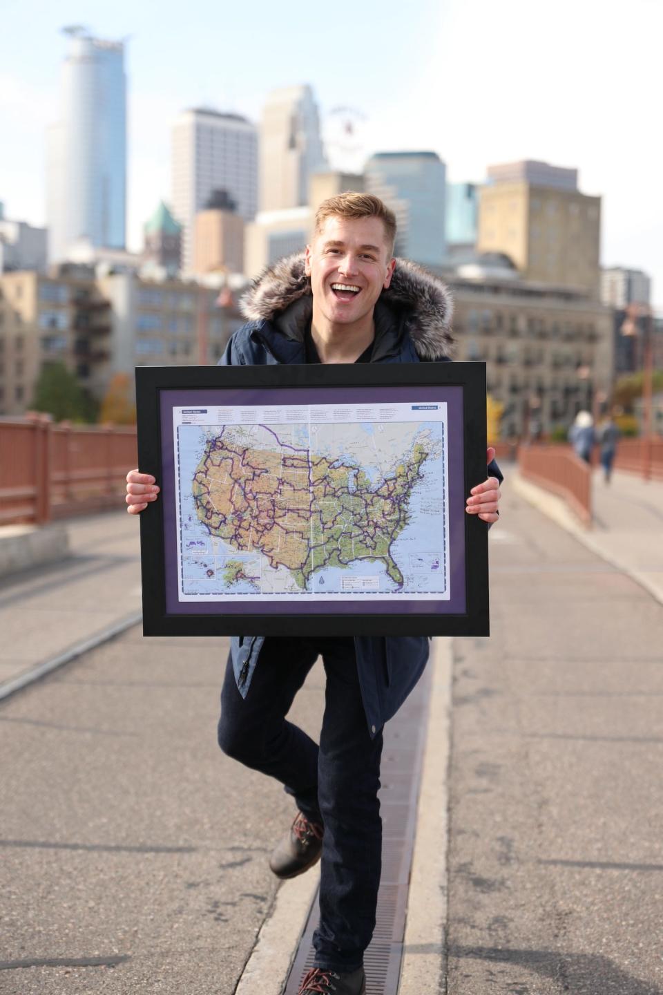 Mikah Meyer stands with a map.