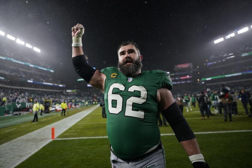 Philadelphia Eagles' Jason Kelce lifts his fist in the air while leaving the field after an NFL football game