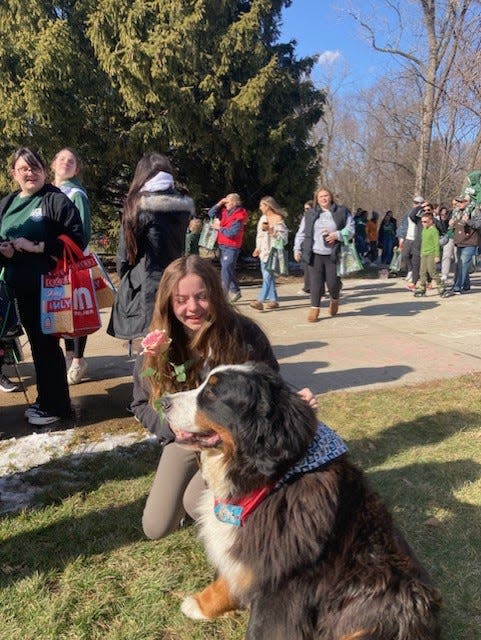 A MSU student visits with one of Cheryl Wassus' service dogs. "My pups are bringing smiles during such a sad time," Wassus of Monroe said.
(Photo: PROVIDED BY CHERYL WASSUS)