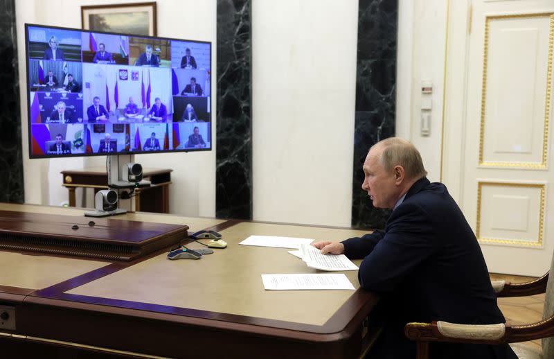 Russian President Vladimir Putin chairs a meeting on fighting wildfires, via video link in Moscow