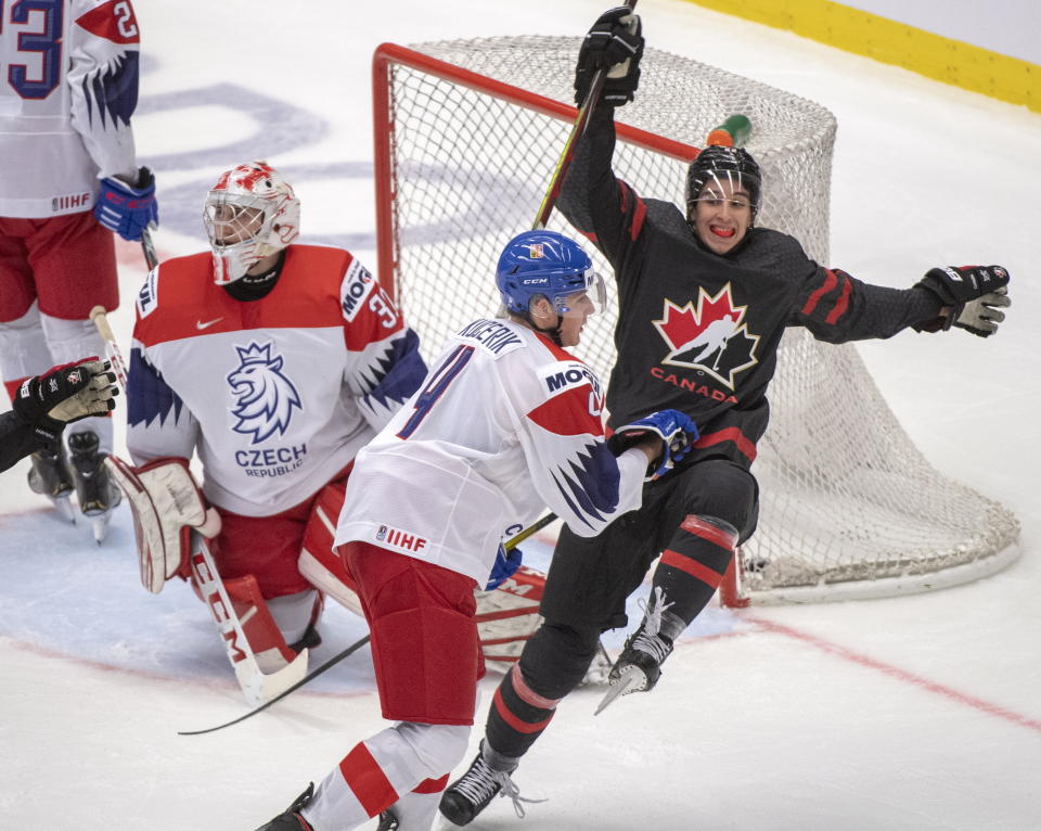 Canada's Dylan Cozens, right, celebrates after scoring the sixth goal of the game for Canada against Czech Republic's goaltender Nick Malik as Czech's Radek Kucerik moves in during the second period at the World Junior Hockey Championships on Tuesday, Dec. 31, 2019 in Ostrava, Czech Republic. (Ryan Remiorz/The Canadian Press via AP)
