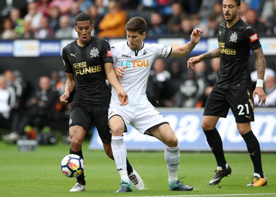 Newcastle United’s Isaac Hayden (left) and Swansea City’s Federico Fernandez (centre) at loggerheads