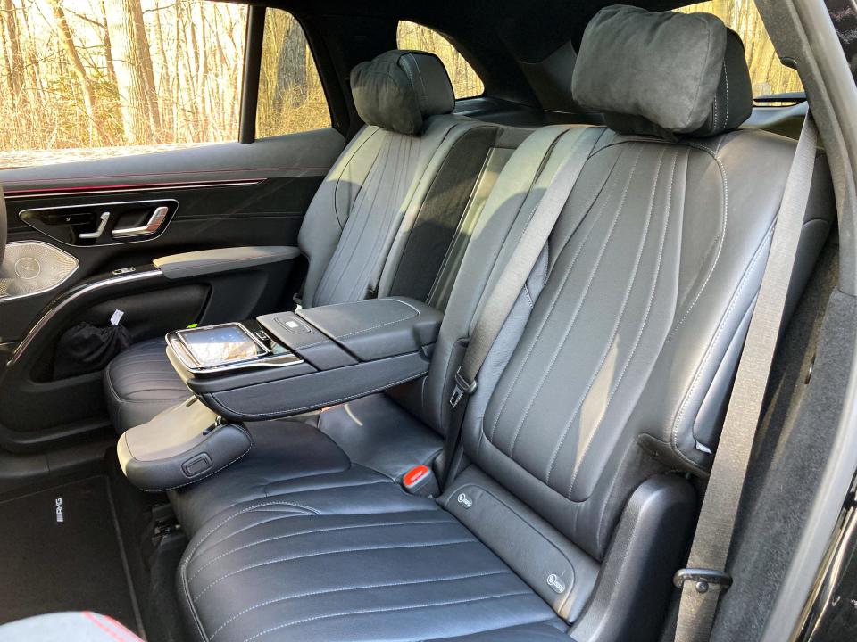 The 2023 Mercedes-Benz EQS SUV's rear seats, with the armrest down and a touchscreen embedded inside.