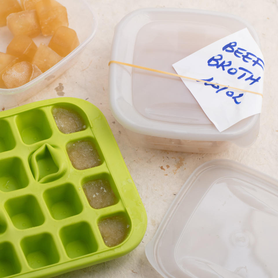 Pouring broth into ice cube trays