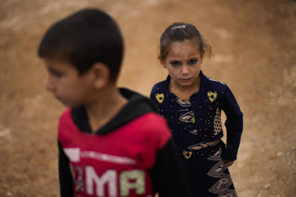 Syrian children wait for donated toys and food to be distributed in a refugee camp for displaced people supported by the Turkish Red Crescent in Sarmada, north of Idlib city, Syria, Thursday, Nov. 25, 2021. (AP Photo/Francisco Seco)