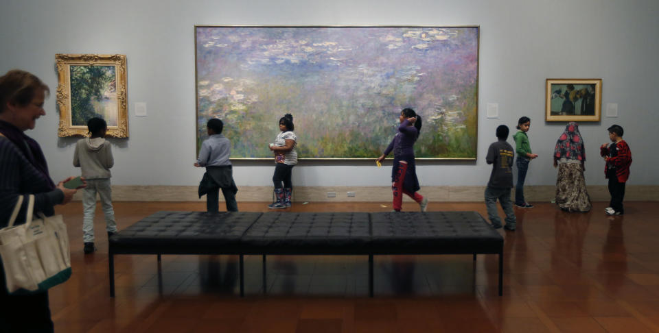 This Feb. 12, 2014 photo shows visitors walking through the galleries of the Nelson-Atkins Museum of Art in Kansas City, Mo. The museum is home to high-caliber collections that include great works ranging from the photography of Edward Steichen to ancient Chinese scrollwork. (AP Photo/Orlin Wagner)