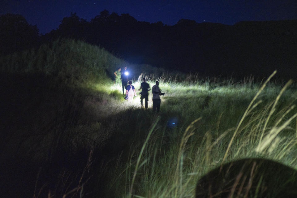 Park rangers and researchers search for elephants in Gabon's Pongara National Park forest, on March 13, 2020. Gabon holds about 95,000 African forest elephants, according to results of a survey by the Wildlife Conservation Society and the National Agency for National Parks of Gabon, using DNA extracted from dung. Previous estimates put the population at between 50,000 and 60,000 or about 60% of remaining African forest elephants. (AP Photo/Jerome Delay)