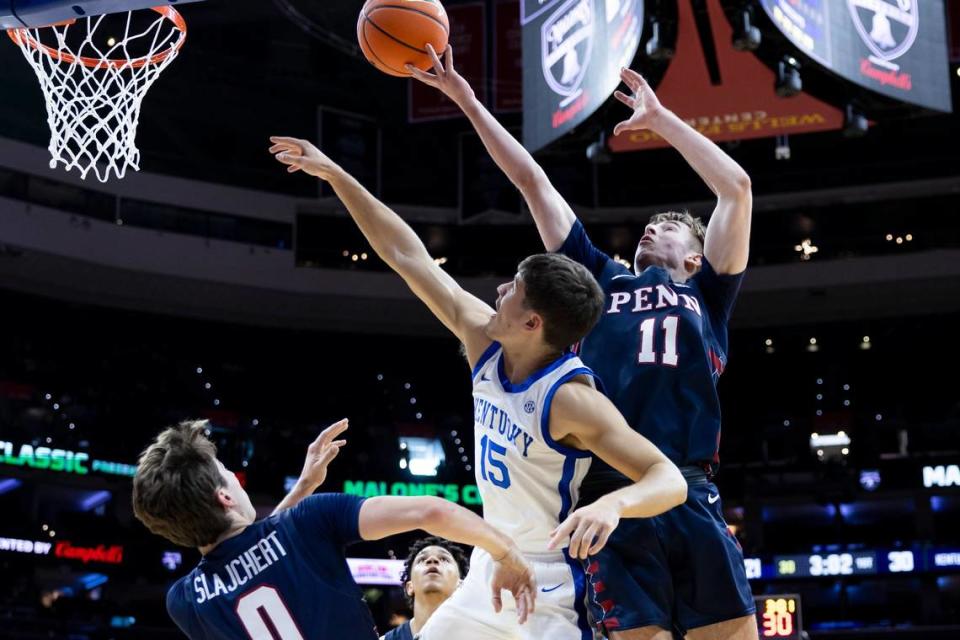 Kentucky guard Reed Sheppard (15) reaches for a rebound against Pennsylvania guard Sam Brown (11).