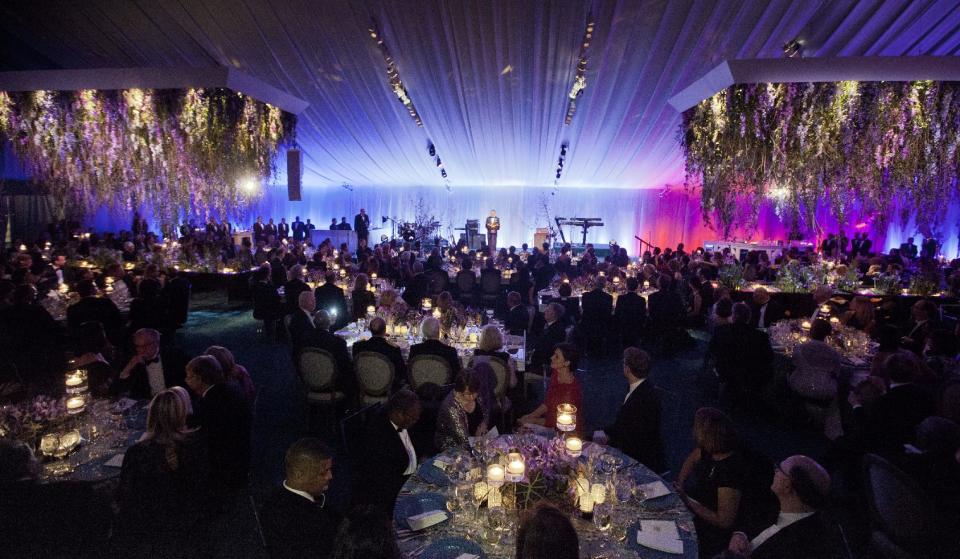 President Barack Obama, center, offers a toast on stage to French President Francois Hollande at the State Dinner, Tuesday, Feb. 11, 2014, on the South Lawn of the White House in Washington. (AP Photo/Pablo Martinez Monsivais)