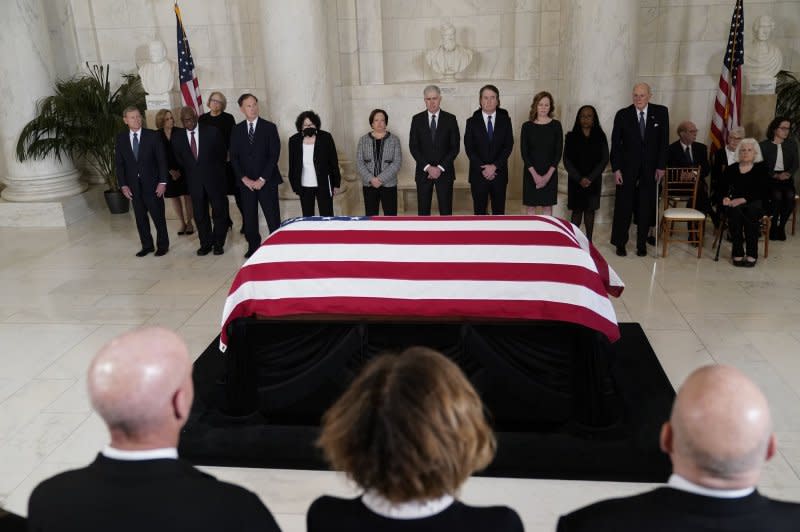 The justices of the U.S. Supreme Court stand before the flag-draped casket of retired Justice Sandra Day O'Connor on arrival at the Supreme Court in Washington on Monday. Pool Photo by Jacquelyn Martin/UPI