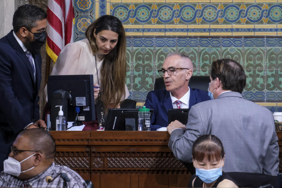 Interim Los Angeles City Council President Mitch O'Farrell, second from right, talks to city staff before the cancellation of the Los Angeles City Council meeting Wednesday, Oct. 12, 2022 in Los Angeles. (AP Photo/Ringo H.W. Chiu)