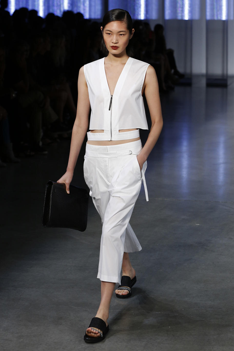 FILE - This Sept. 6, 2013 file photo shows a model wearing sandals as she models the Helmut Lang Spring 2014 collection during Fashion Week in New York. In shoe stores this year, you could see a trend toward flats, including a notable reinterpretation of those chunky Birkenstocks. (AP Photo/John Minchillo, File)