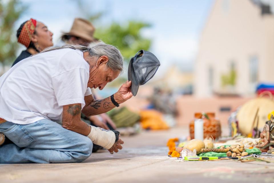 People pay homage in  protest against the reinstallation of a statue of a 16th-century New Mexico conquistador at the Rio Arriba County building in Espanola (Getty Images)