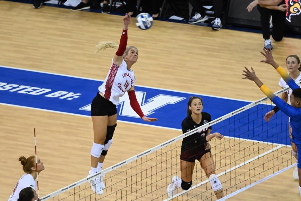 Dec 15, 2022; Omaha, Nebraska, US; Louisville Cardinals Anna DeBeer (14) attacks from the back row against the Pittsburgh Panthers in the semi-final match at CHI Health Center. Mandatory Credit: Steven Branscombe-USA TODAY Sports