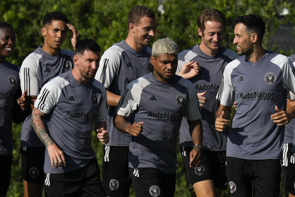 Lionel Messi, front left, and Sergio Busquets, right, jog alongside forward Josef Martinez, center, at the start of a training session for the Inter Miami MLS soccer team Tuesday, July 18, 2023, in Fort Lauderdale, Fla.(AP Photo/Rebecca Blackwell)