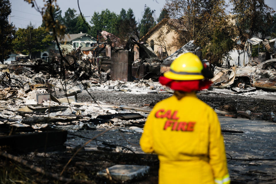 A Cal Fire employee surveys damage in the Coffey Park neighborhood of Santa Rosa on Friday. (Photo: Elijah Nouvelage via Getty Images)