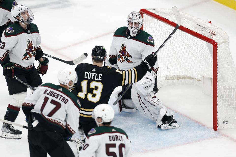 Boston Bruins' Charlie Coyle (13) celebrates his goal against Arizona Coyotes' Connor Ingram (39) during the first period of an NHL hockey game, Saturday, Dec. 9 2023, in Boston. (AP Photo/Michael Dwyer)