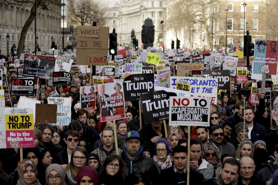 People listen to speakers during a rally at the end of a protest march on Whitehall in London, against U.S. President Donald Trump's ban on travellers and immigrants from seven predominantly Muslim countries entering the U.S., Saturday, Feb. 4, 2017. (AP Photo/Matt Dunham)