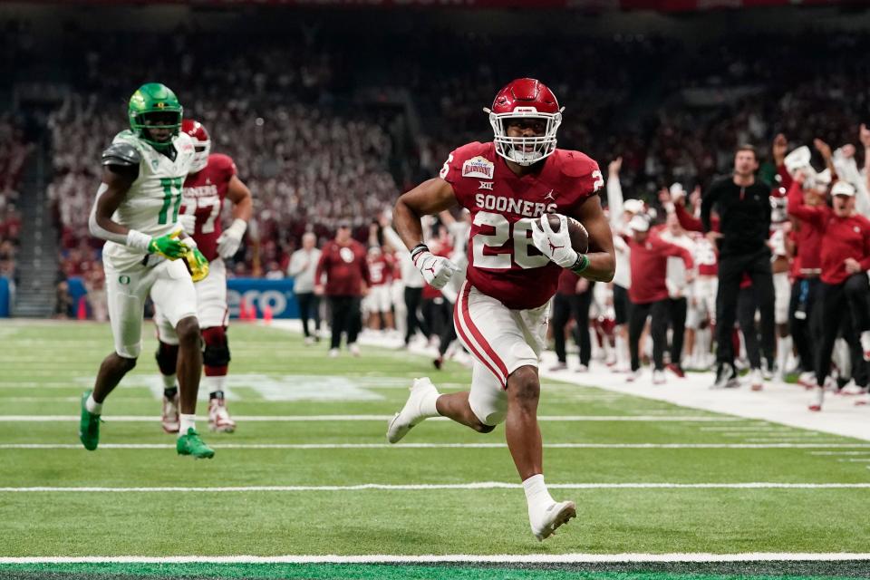 Oklahoma running back Kennedy Brooks (26) runs for a touchdown against Oregon during the first half of the Alamo Bowl NCAA college football game Wednesday, Dec. 29, 2021, in San Antonio. (AP Photo/Eric Gay)