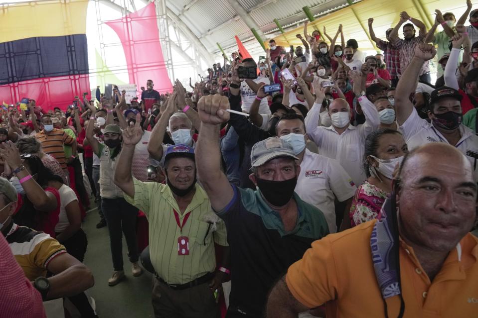 Party faithful cheer for Former foreign minister Jorge Arreaza during an event in Barinas, Venezuela, Sunday, Dec. 5, 2021. President Nicolas Maduro named Arreaza via a livestream as the ruling party's candidate to the gubernatorial race for Barinas state. The announcement came less than a week after the country's highest court disqualified opposition candidate Freddy Superlano for the governorship of Barinas as he was leading the vote count, a move that has become emblematic of what the opposition says are unfair election conditions. (AP Photo/Ariana Cubillos)