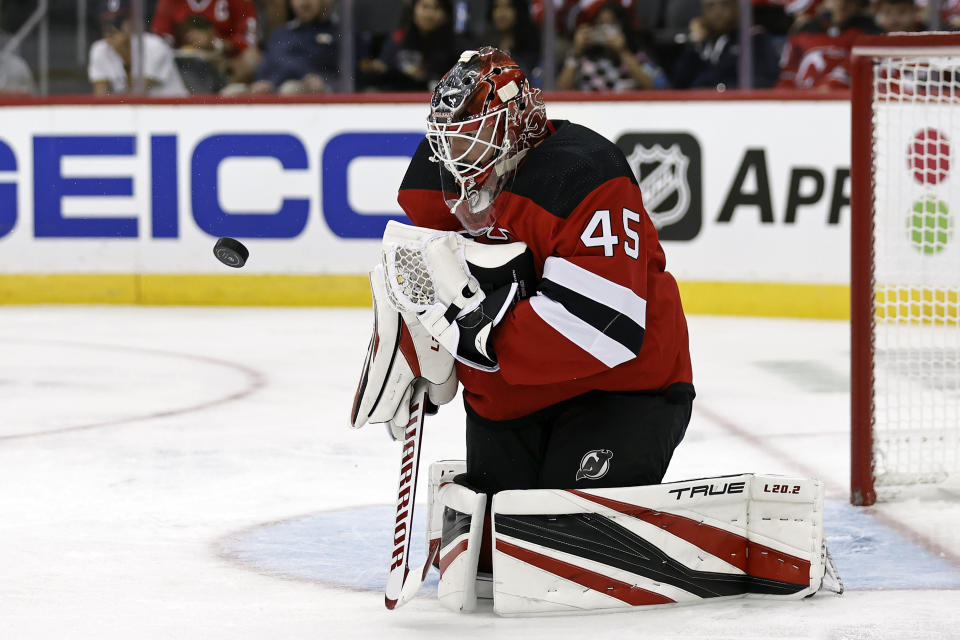 New Jersey Devils goaltender Jonathan Bernier makes a save against the Chicago Blackhawks during the second period of an NHL hockey game Friday, Oct. 15, 2021, in Newark, N.J. (AP Photo/Adam Hunger)