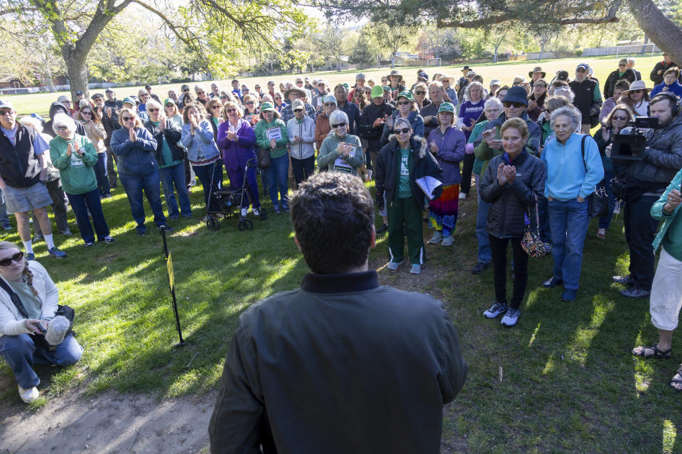 Volunteers supporting the Idaho open primaries ballot initiative cheer as Luke Mayville, front, announces that they have reached their goal of 90,000 signatures during a gathering at Ivywild Park in Boise, Idaho on April 27, 2024. Voters in at least two states – Democratic-leaning Oregon and Nevada – will decide this fall whether to institute new election processes that include ranked voting. In deeply conservative Idaho, groups are pushing for a November ballot initiative that would overturn a ban on ranked voting that was passed last year by the Republican-led Legislature. (AP Photo/Kyle Green)