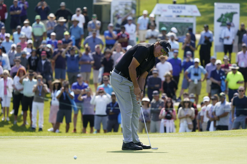 Fans watch as Phil Mickelson putts on the 11th green during the first round of the U.S. Open Golf Championship, Thursday, June 17, 2021, at Torrey Pines Golf Course in San Diego. (AP Photo/Marcio Jose Sanchez)