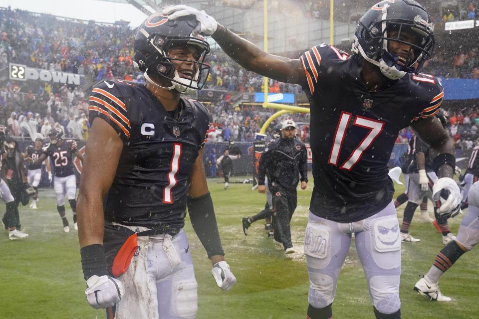 Chicago Bears' Justin Fields and Ihmir Smith-Marsette celebrate after an NFL football game against the San Francisco 49ers Sunday, Sept. 11, 2022, in Chicago. The Bears won 19-10. (AP Photo/Nam Y. Huh)