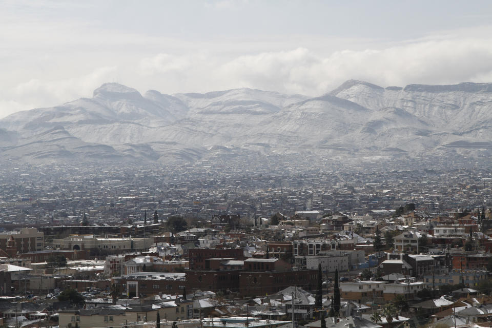 Snow obscures writing on the side of the mountains above Ciudad Juarez, Mexico, as seen from El Paso, Texas, on Wednesday, Feb. 5, 2020. A few inches of snow led to slow starts at schools in El Paso and caused hour-long delays on local roads. (AP Photo/Cedar Attanasio)