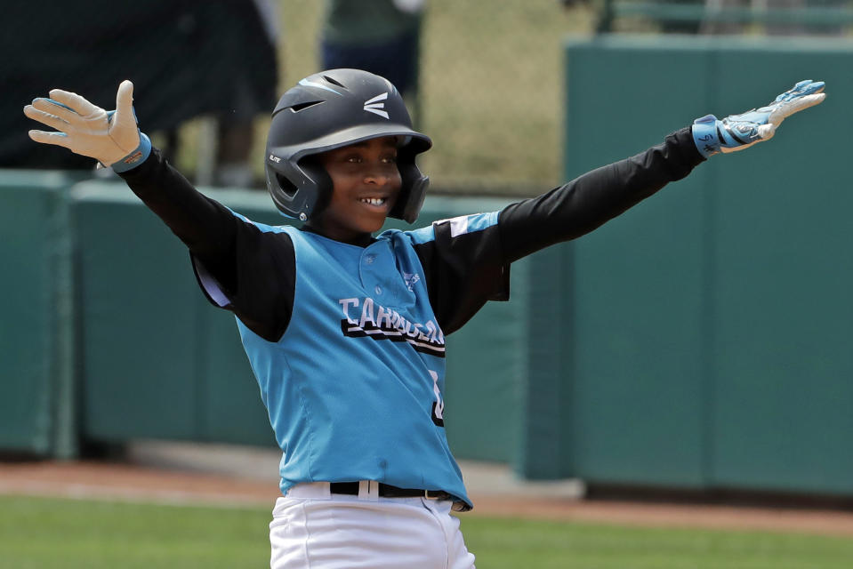 Curacao's Shendrion Martinus celebrates on second base after driving in two runs with a double off Japan's Taishi Kawaguchi in the third inning of the International Championship baseball game at the Little League World Series tournament in South Williamsport, Pa., Saturday, Aug. 24, 2019. (AP Photo/Gene J. Puskar)