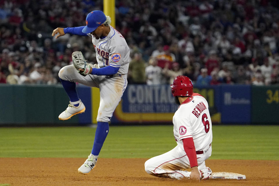 Los Angeles Angels' Anthony Rendon, right, is forced out at second on a hit by Brandon Marsh as New York Mets shortstop Francisco Lindor jumps over him during the fifth inning of a baseball game Friday, June 10, 2022, in Anaheim, Calif. (AP Photo/Mark J. Terrill)