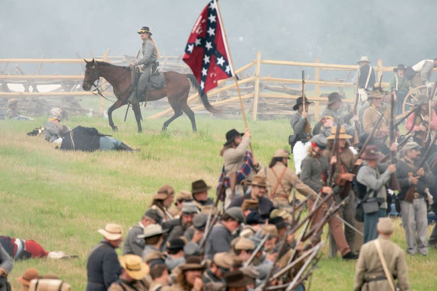 A reenactor waves a confederate flag on the battlefield during the 160th reenactment of the Battle of Gettysburg, at Daniel Lady Farm in Gettysburg, Pennsylvania, on June 30, 2023. The Battle of Gettysburg, which is considered to be the bloodiest battle ever fought on US soil, occurred from July 1-July 3, 1863 during the US Civil War. Approximately 10,000 Union and Confederate troops were left dead, and another 30,000 wounded. Each year, the Gettysburg Battlefield Preservation Association holds a reenactment on the weekend closest to the original battle, hosting living history demonstrations and military reenactments to help teach people the history of the Civil War battle. (Photo by Stefani Reynolds / AFP) (Photo by STEFANI REYNOLDS/AFP via Getty Images)